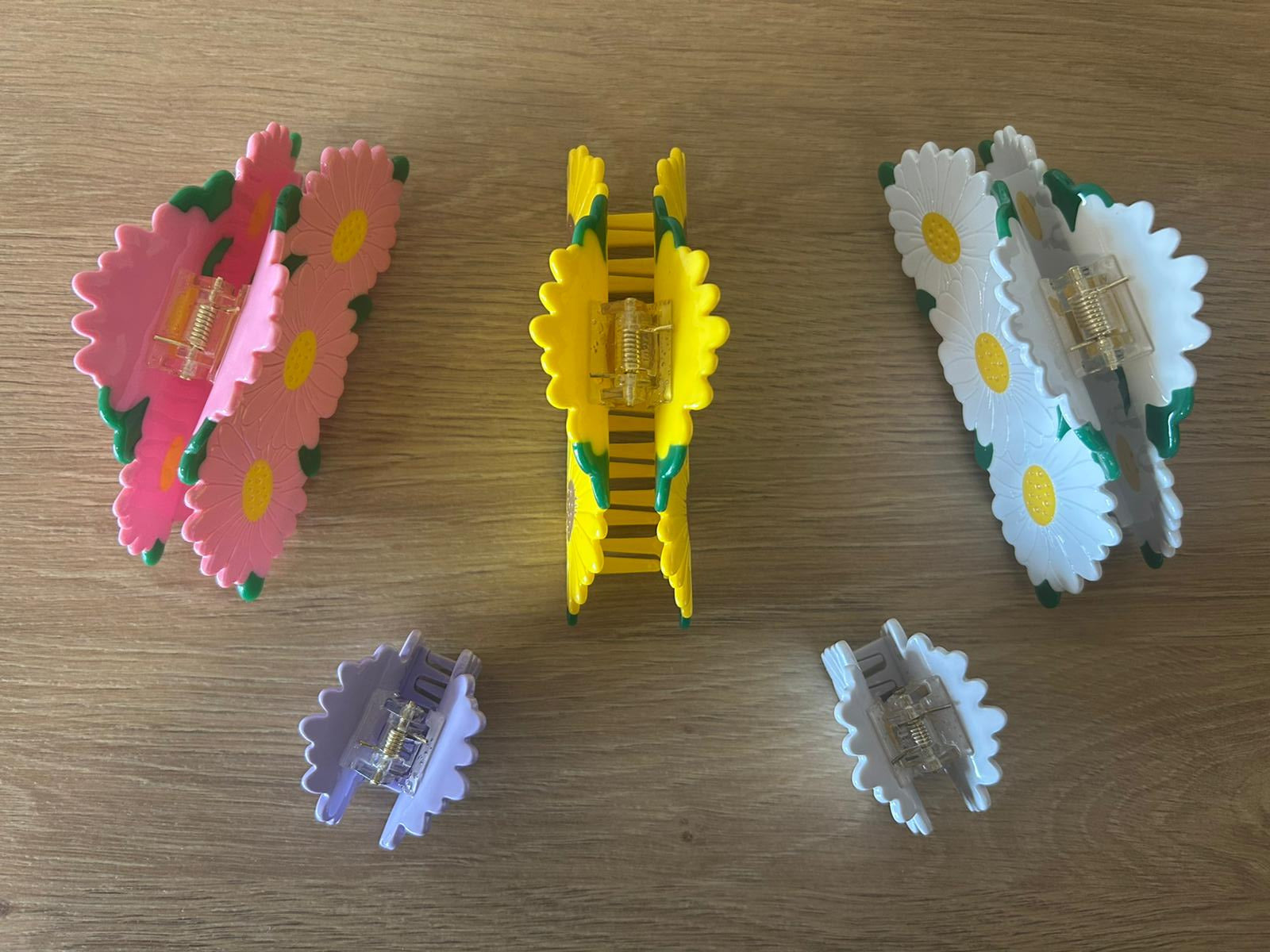 All Daisy Bunch Hair Claws Together Lying Angled Organized Next to One Another - Top View